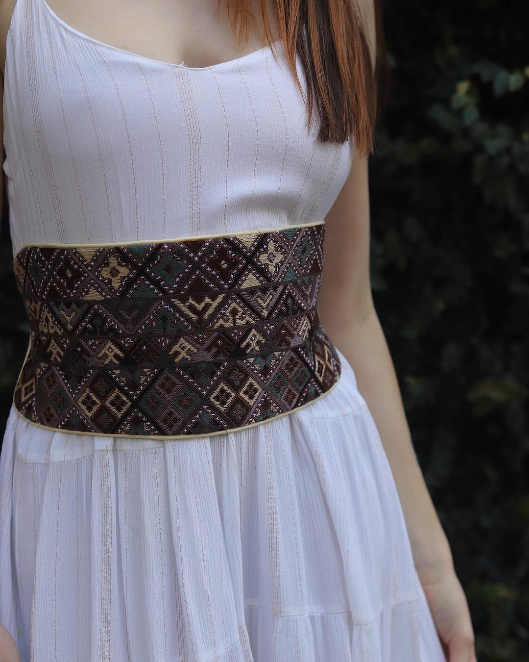 Close view of the diamond embroidery on the brown Earth Diamond Belt