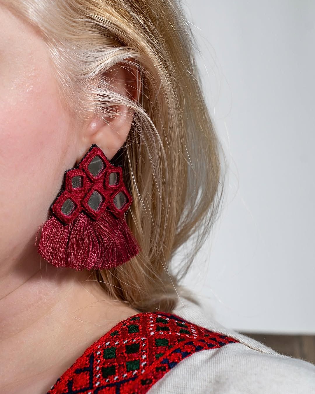 Red mirror work earring with a full red tassel