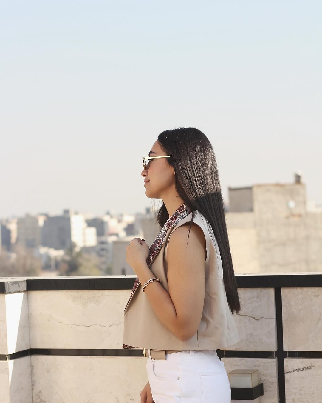 Side view of the sand coloured vest on a rooftop