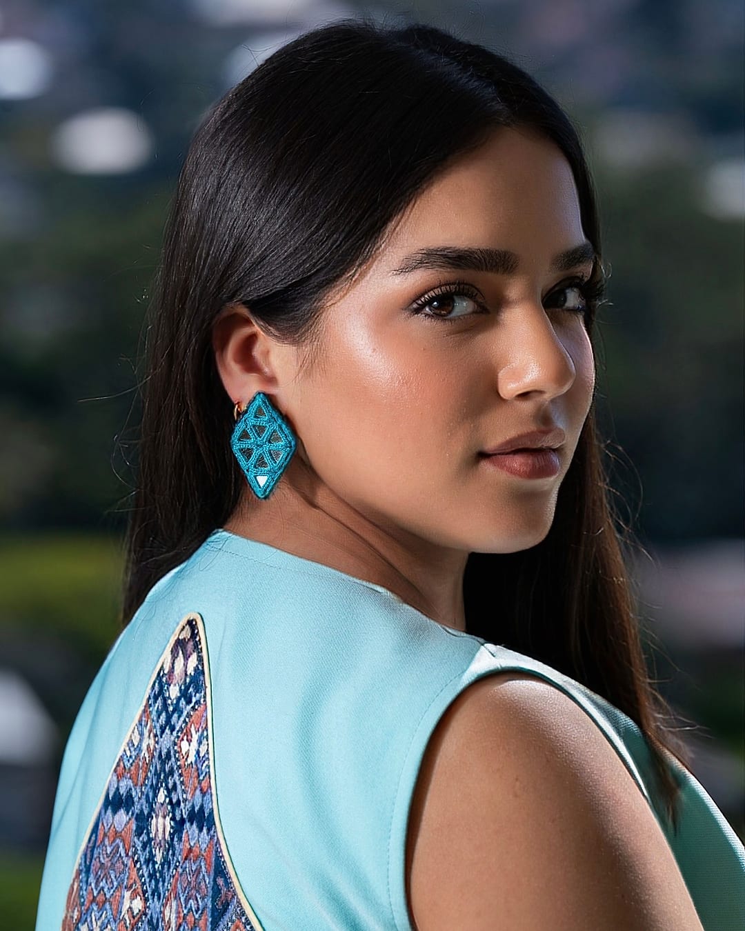 Over the shoulder view of the mint vest and its embroidered back panel